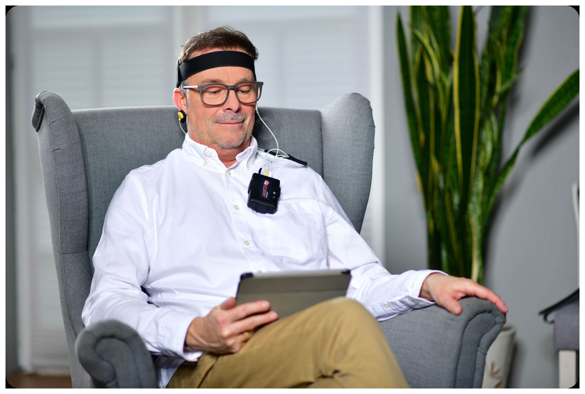 neuroscientist monitoring brain activity on screen with electrode interface headset in modern laboratory setting