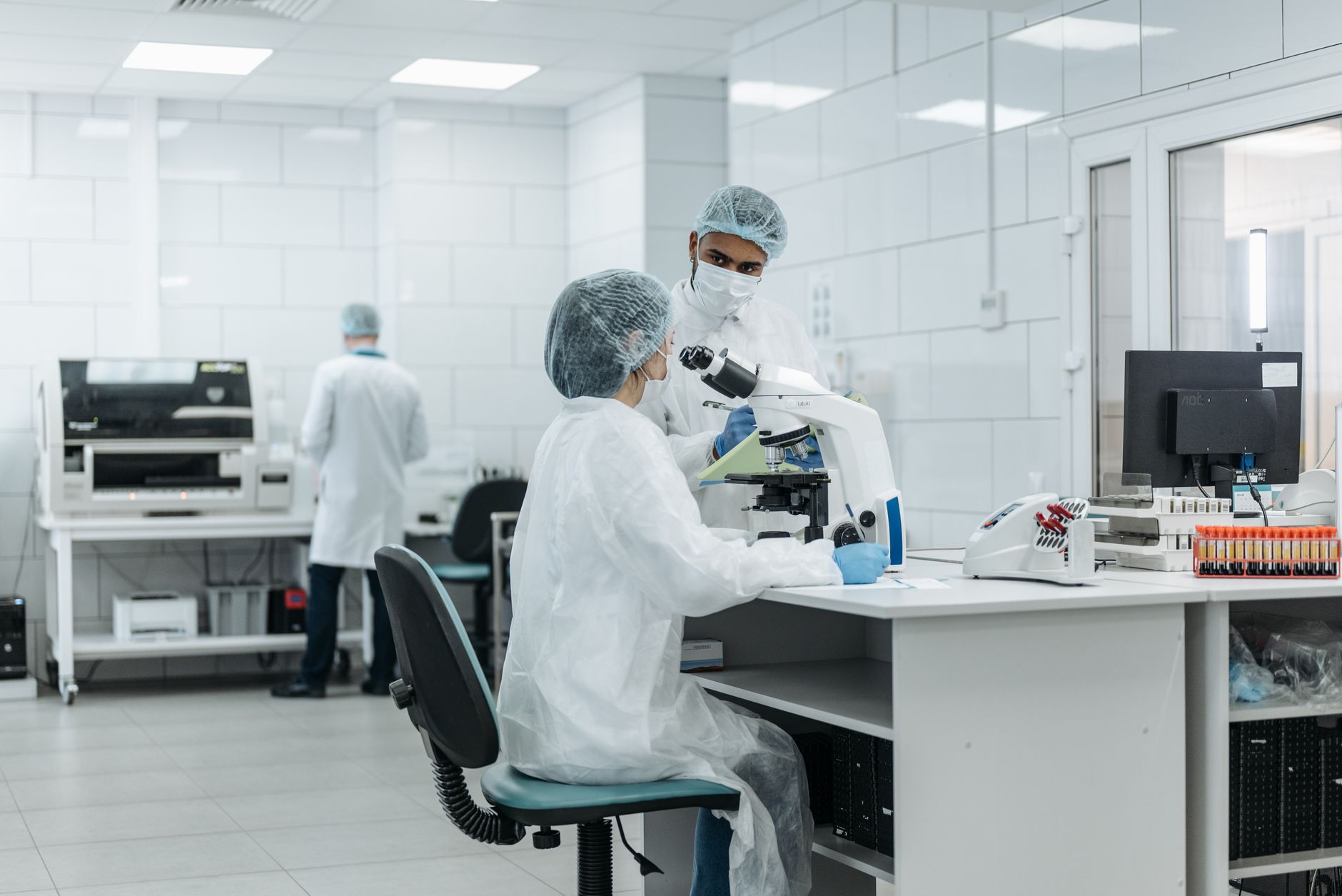 scientist laboratory glowing fluorescent molecules microscope high-tech equipment modern research facility biotech