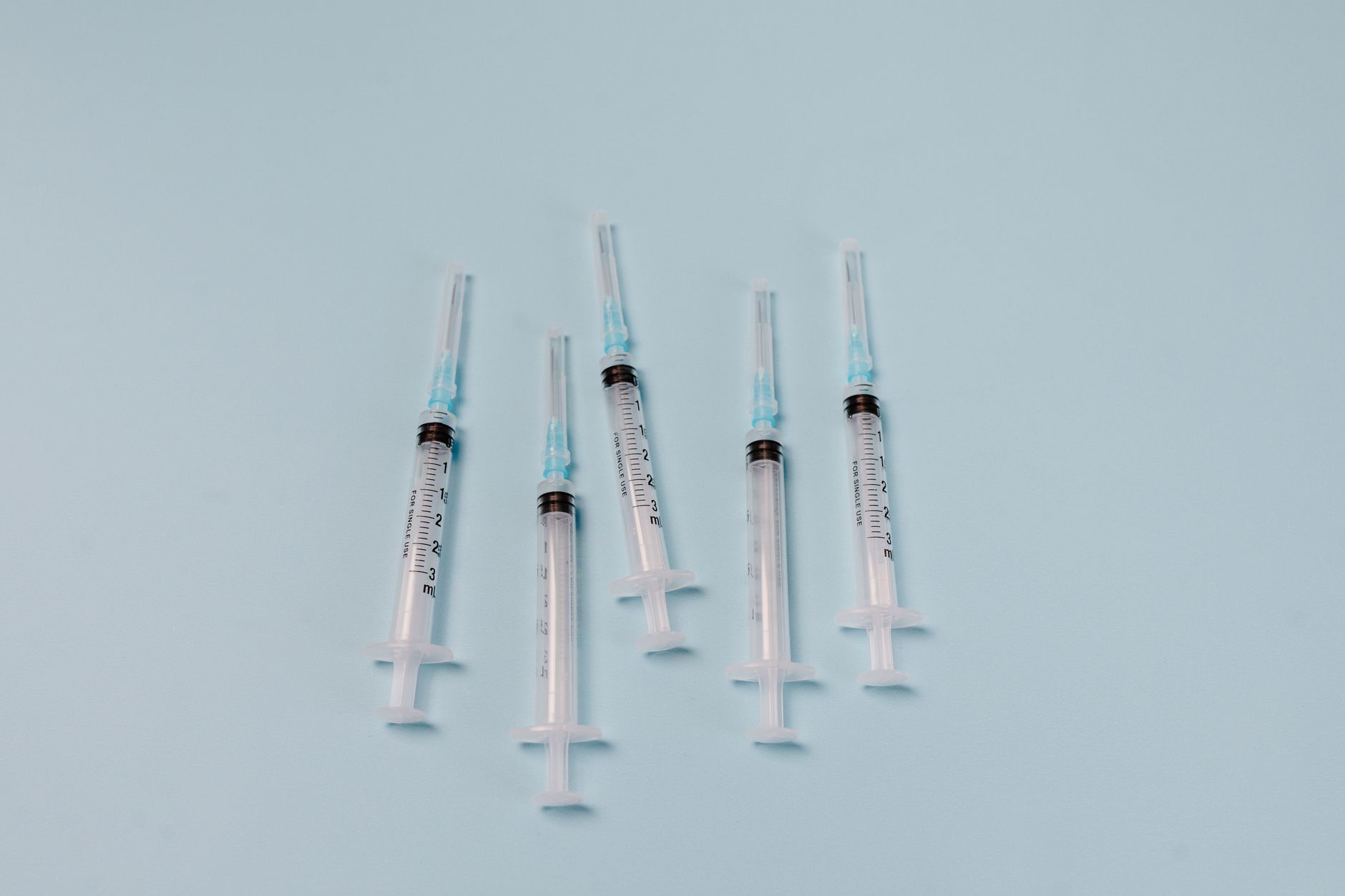 medical microsyringe injection or fluid-jet vaccine administration technology, close-up modern vaccine delivery system, laboratory precision equipment