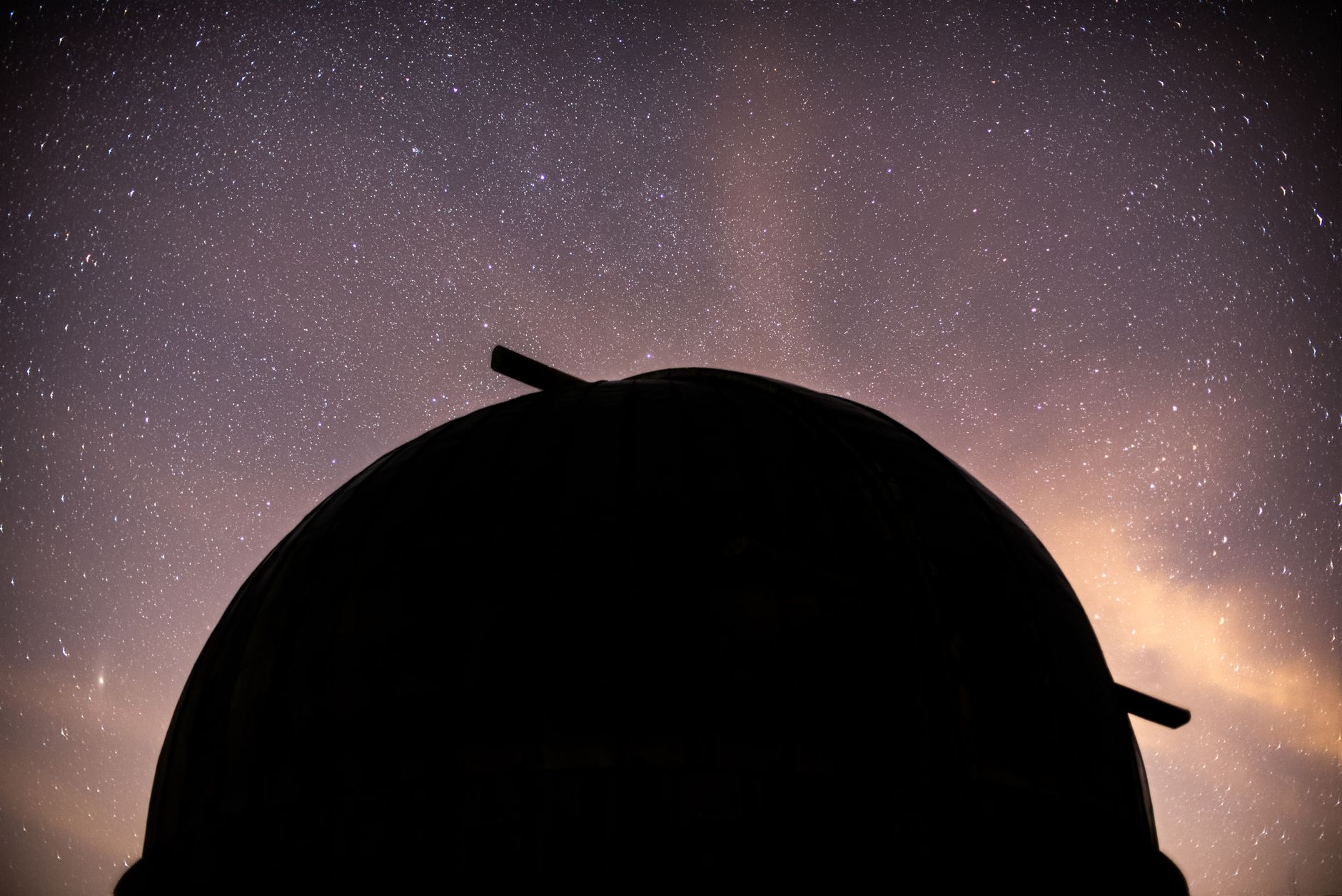 astronomical observatory telescope dome at night under starry sky Chile mountains