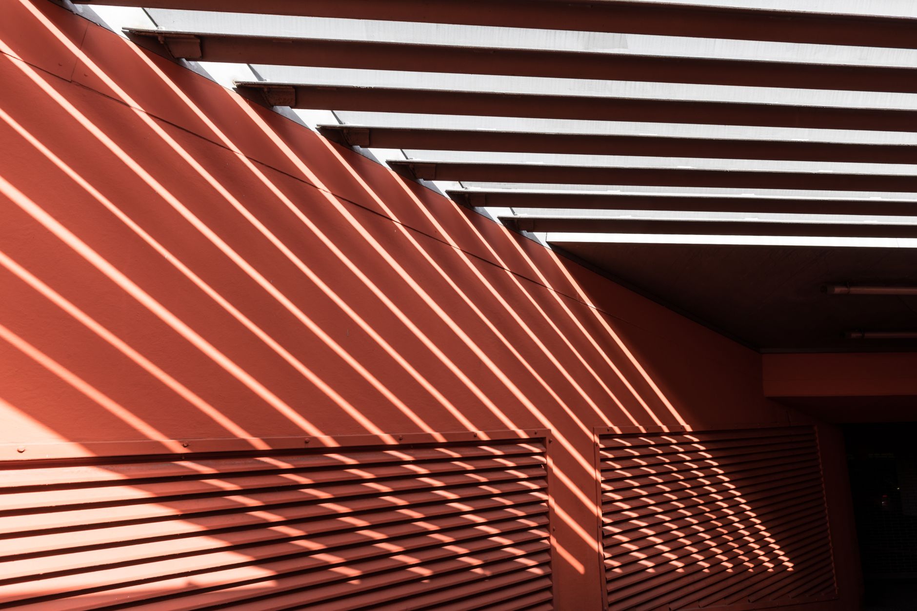 modern building facade glowing with subtle light under intense summer sun
