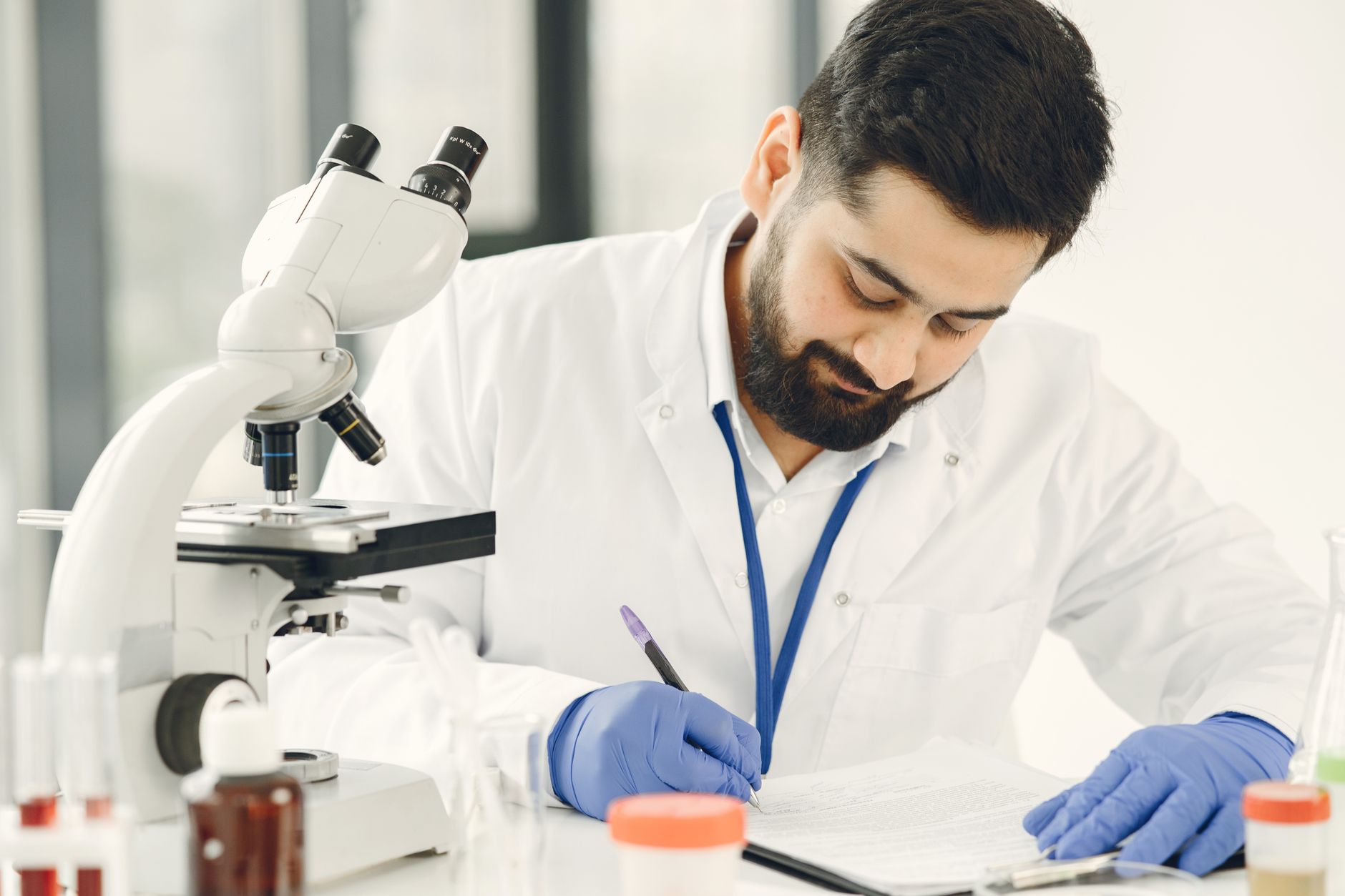 marine biologist examining fish samples under microscope laboratory science research