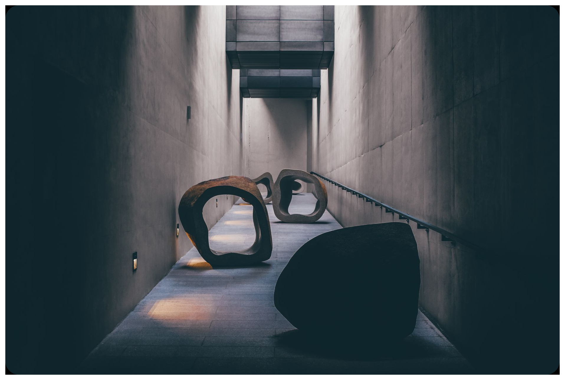 modern art installation with sculptures metal blocks white gallery dramatic lighting contemporary art