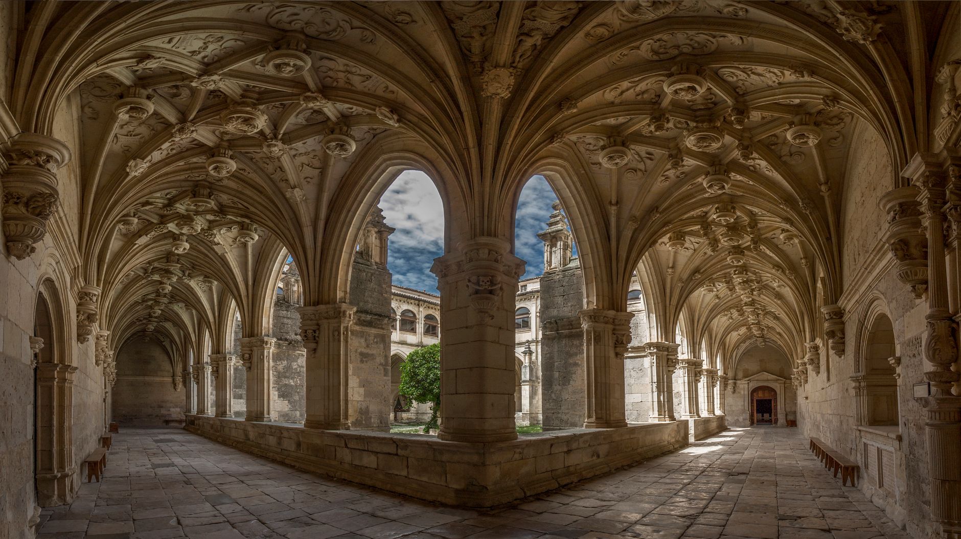 ornate stone cloister convento san francisco decorated vaults peaceful courtyard medieval fountain