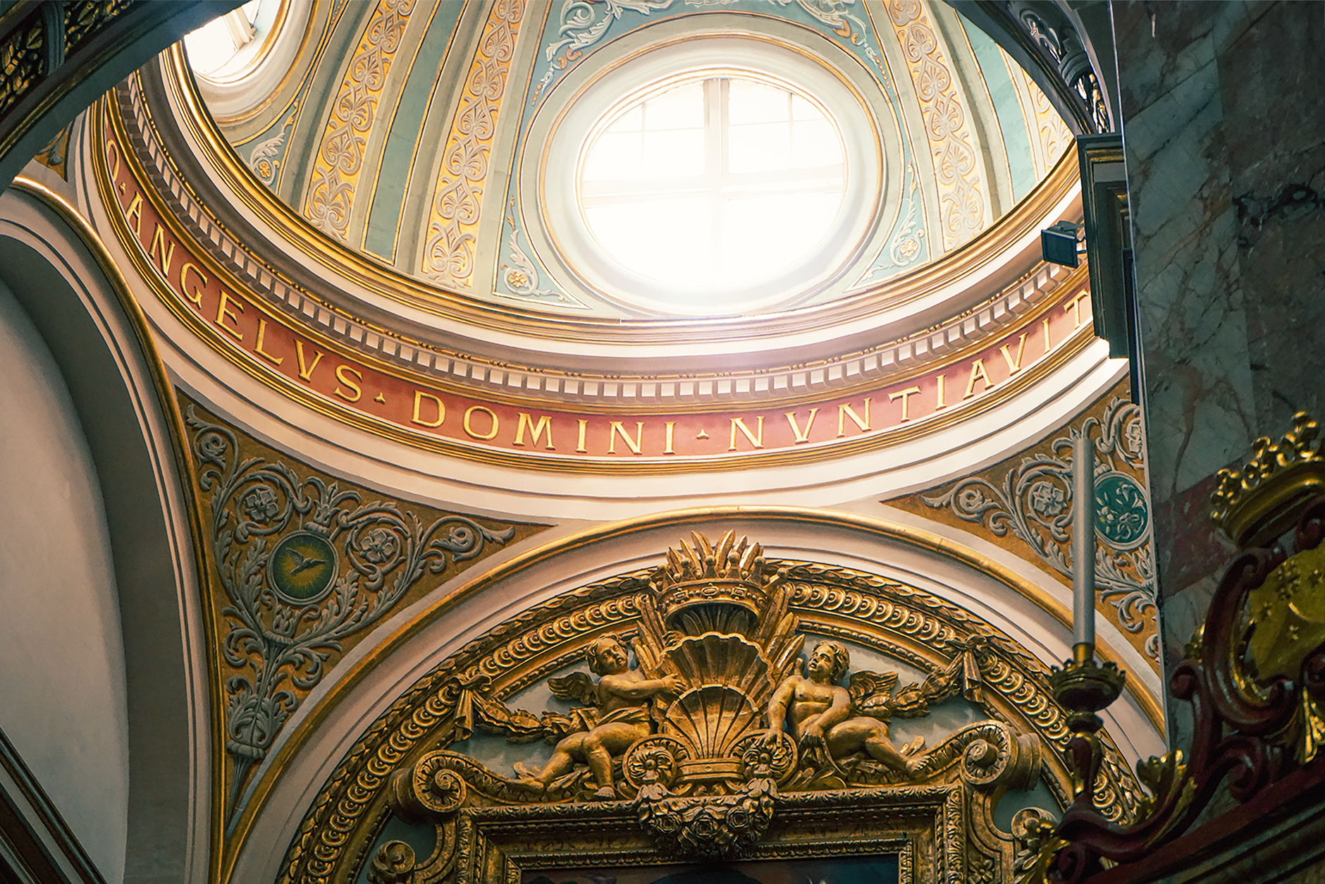 close-up of intricate baroque gilded carved details and religious iconography on restored altar with meticulous restoration work visible