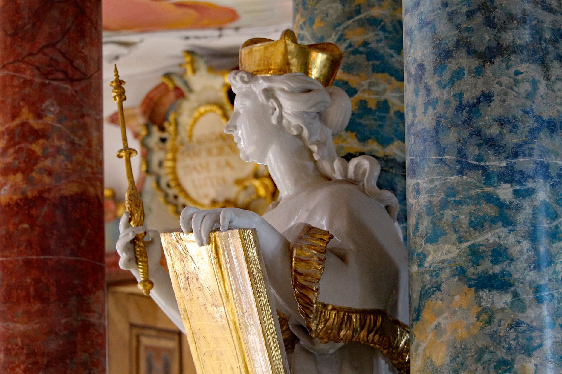 renaissance wooden religious sculpture with gold leaf in dim monastery chapel dramatic light