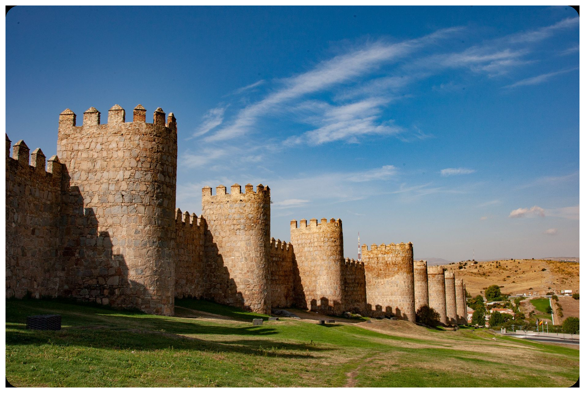 ancient fortified walls of Avila spain stone towers medieval architecture sunset dramatic lighting defensive castle