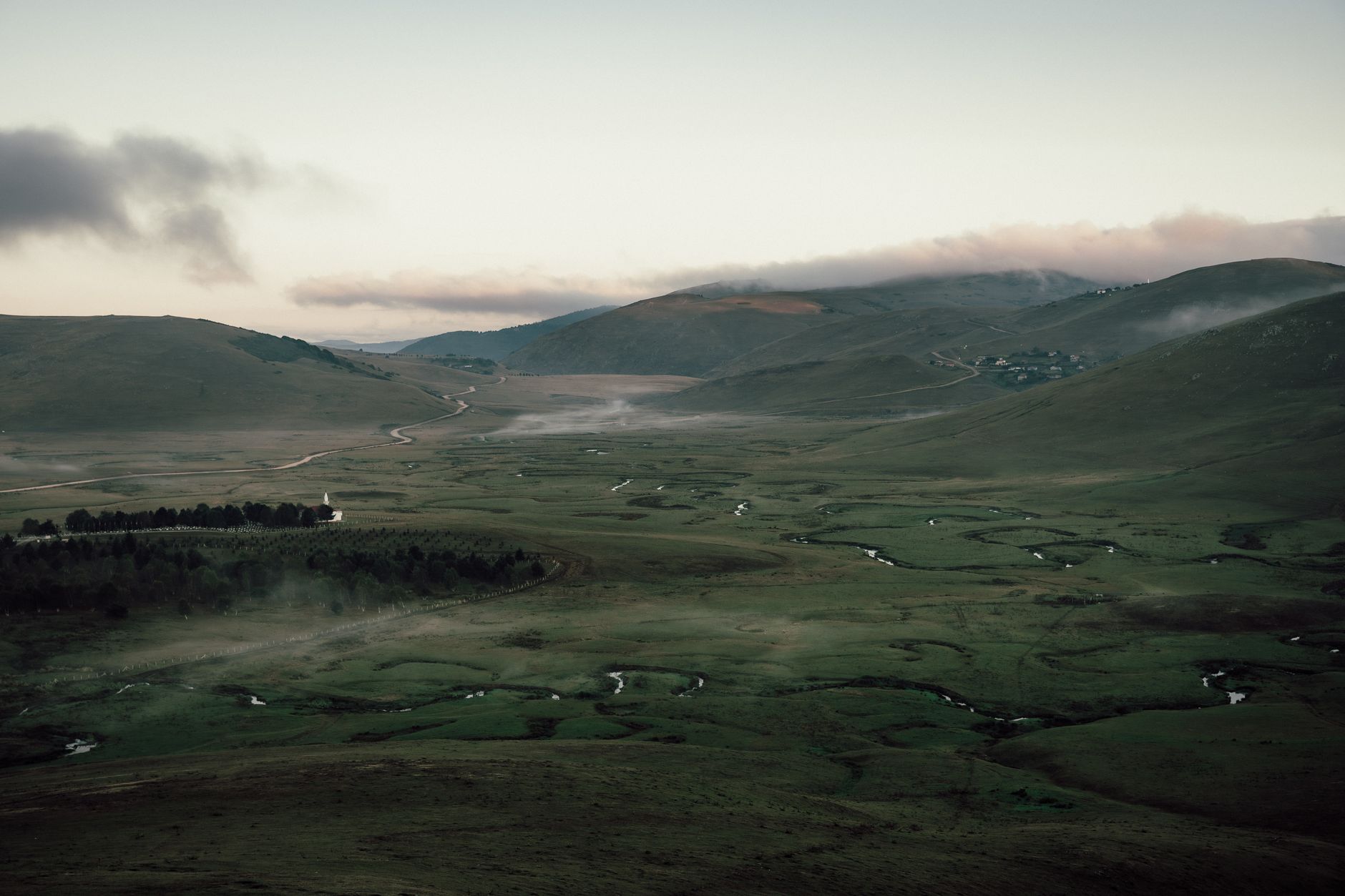 prehistoric mountain valley river landscape misty dawn light neanderthal era