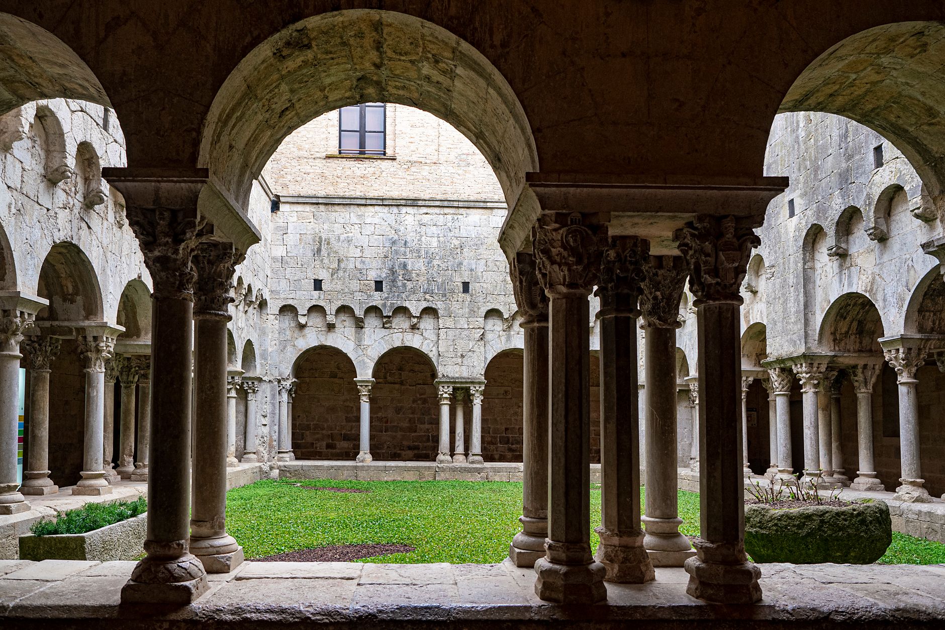 medieval stone monastery courtyard dramatic golden light Aragon Spain