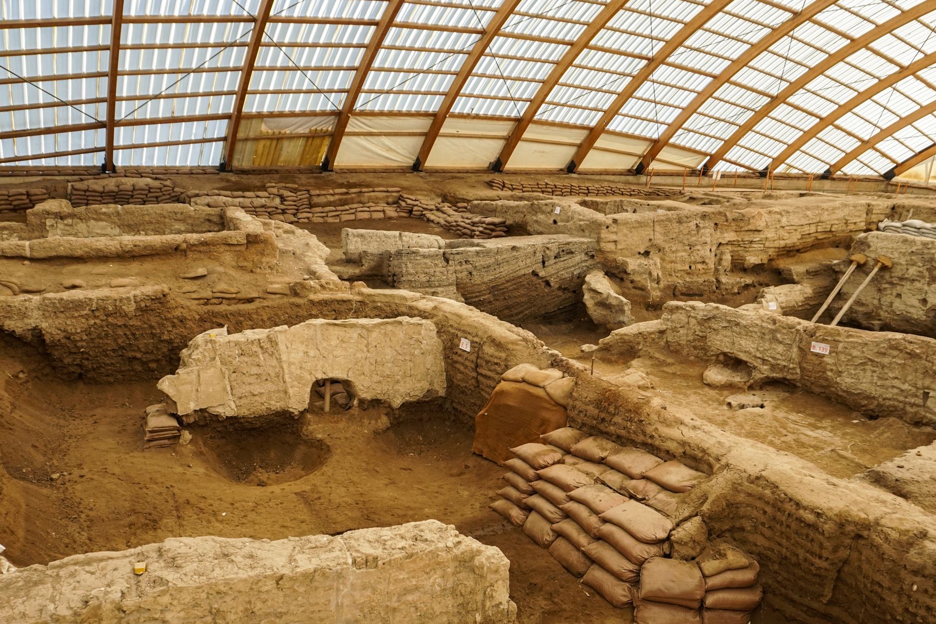 archaeologists excavating ancient plaza trench in Huelva Spain golden afternoon light