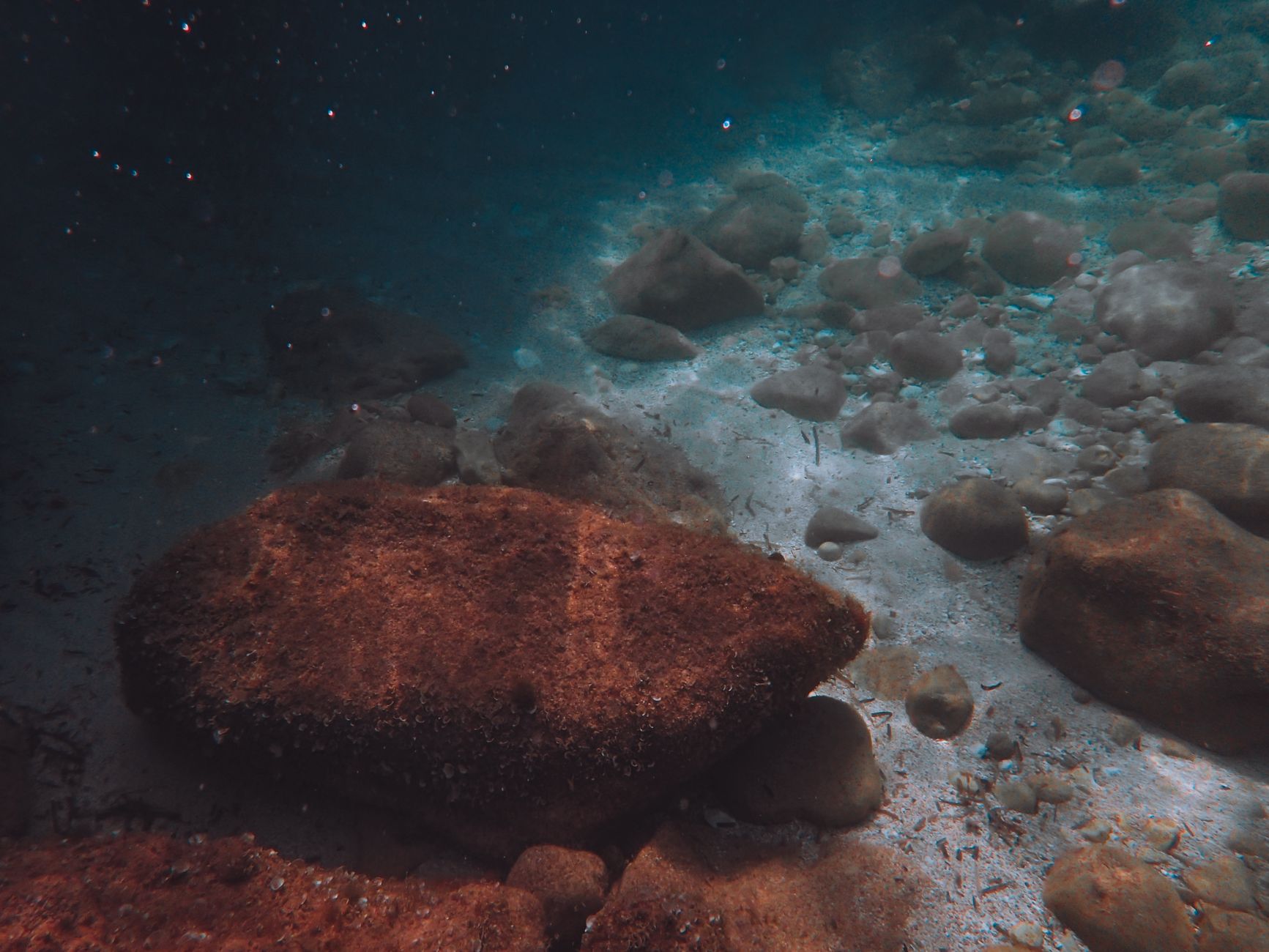 ancient roman stone anchors on mediterranean seabed near Tabarca island dramatic underwater light